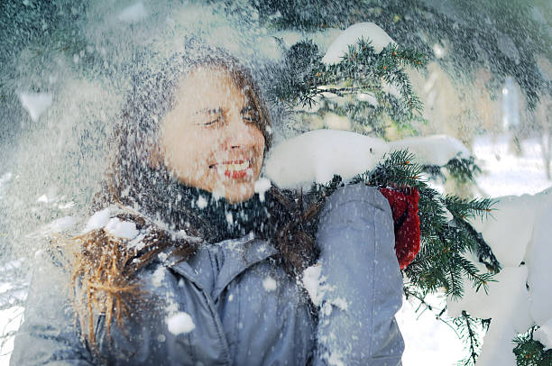 istock Young girl among spruce branches in winter 635873754