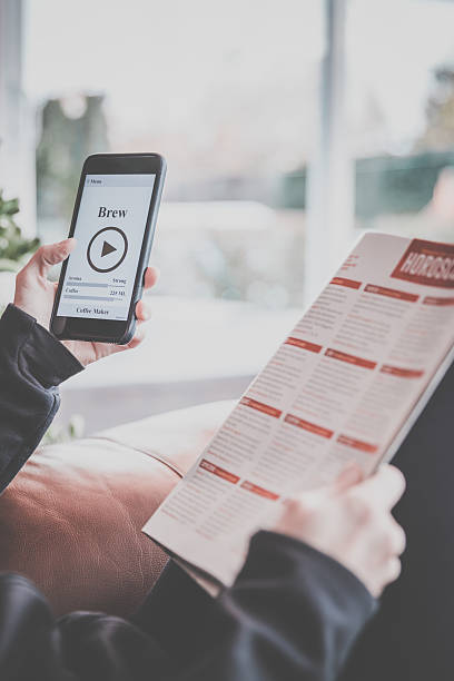istock Woman Using Coffee Maker App on Mobile Phone 635874590