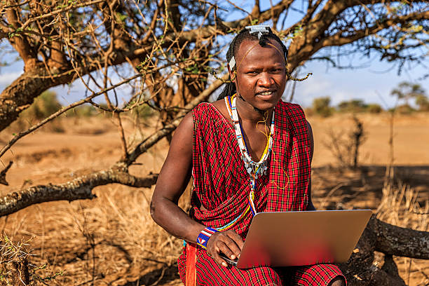 istock Warrior from Maasai tribe using laptop, Kenya, Africa 635874774