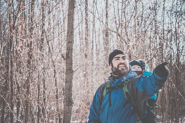 istock Father Backpacking Hiking with Baby in Winter Forest 635874920