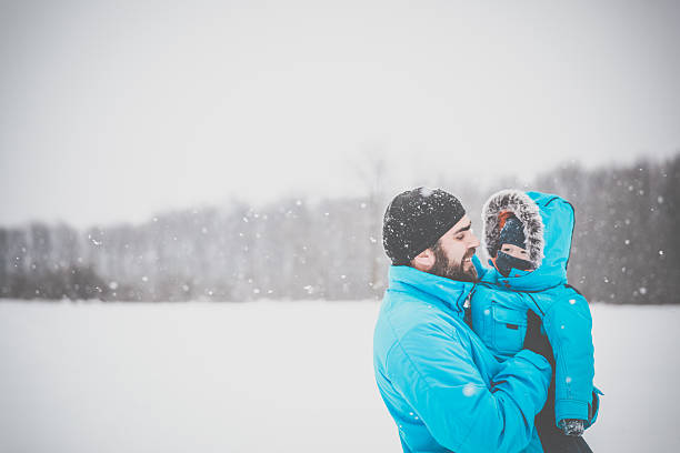 istock Father and Son in Winter Forest Snowstorm 635875426