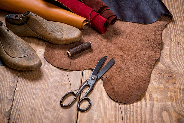 istock Set of leather craft tools on wooden background. 635876978