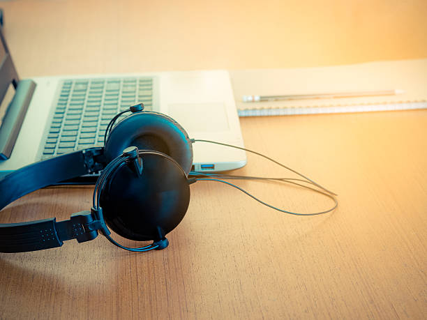 istock Headphones and Notebook Computers on desk office. 635877858
