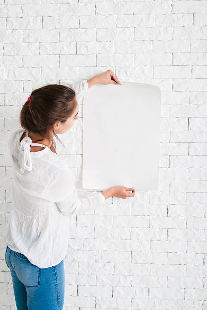 istock Young woman looking at empty sheet of paper 635878636