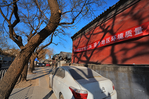China, Beijing - December 5, 2016: Shichahai area. A banner that promotes landscaping. A car stops there.