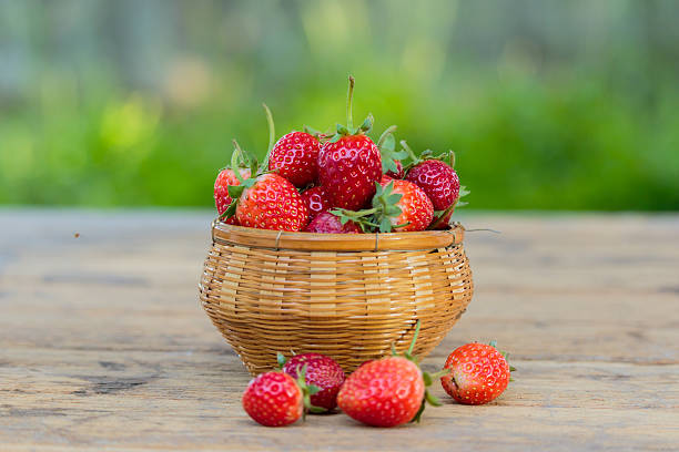 istock Ripe strawberries with leaves in wicker basket 635885132