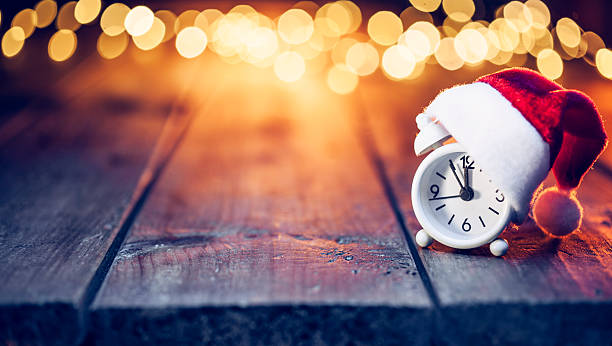 navidad de última hora - despertador santa hat desenfocado de madera - clock time alarm clock urgency fotografías e imágenes de stock