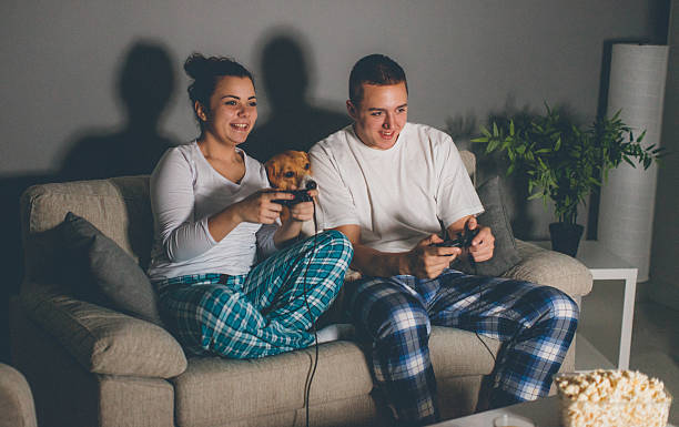 istock Joyful couple playing video games together on the sofa 635890094
