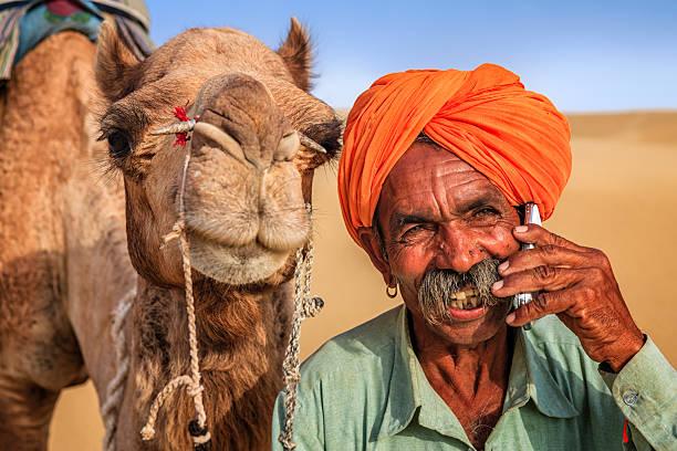 istock Indian man using a mobile, desert village, India 635890240