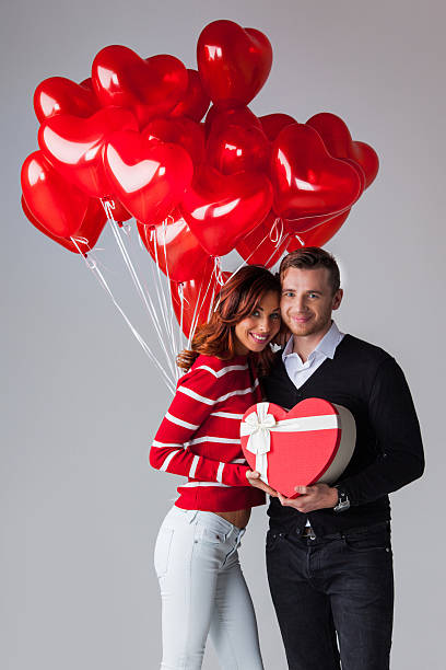 istock Couple with heart shaped balloons 635893344