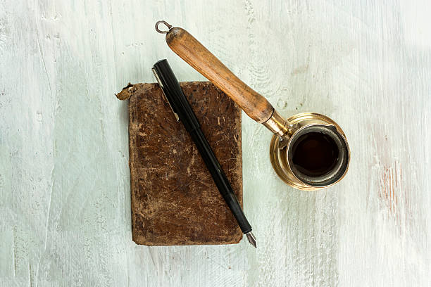 istock Vintage coffee pot, old book and nib pen 635898176