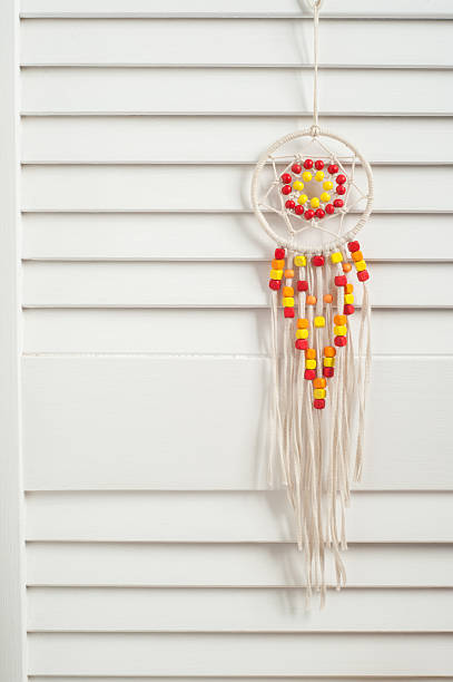 istock Rustic dream catcher with red and yellow wooden beads 635898566