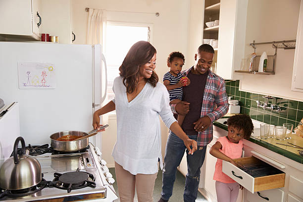 istock Family At Home Preparing Meal In Kitchen Together 635899680