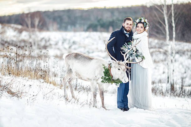 istock Happy bride and groom stand with a deer. 635900780