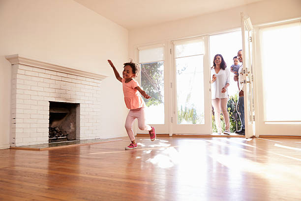 istock Excited Family Explore New Home On Moving Day 635900810