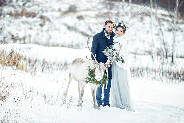 istock The bride and groom stand with a deer. 635900856