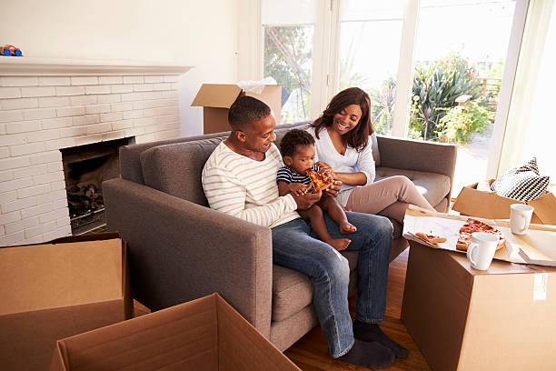 istock Family Take A Break On Sofa With Pizza On Moving Day 635900866