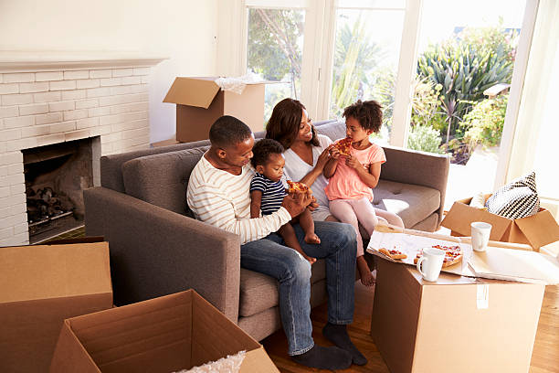 istock Family Take A Break On Sofa With Pizza On Moving Day 635900870