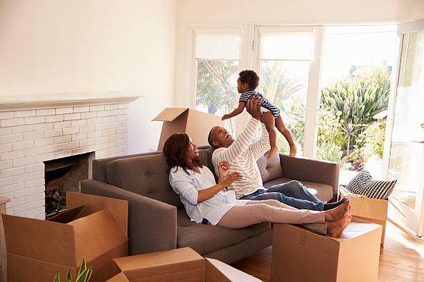 Parents Take A Break On Sofa With Son On Moving Day Parents Take A Break On Sofa With Son On Moving Day physical activity stock pictures, royalty-free photos & images
