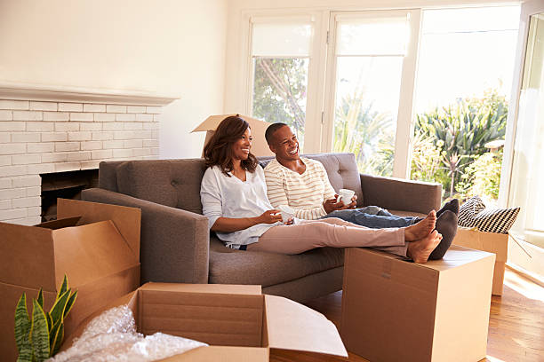 istock Couple On Sofa Taking A Break From Unpacking On Moving Day 635900908