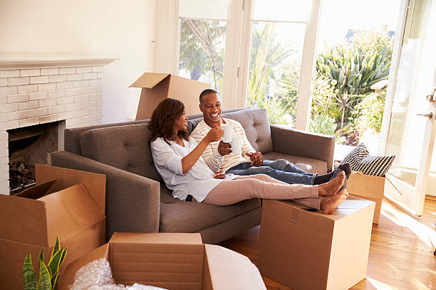 istock Couple On Sofa Taking A Break From Unpacking On Moving Day 635900950