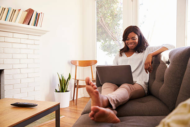 istock Woman Relaxing On Sofa At Home Using Laptop 635900962