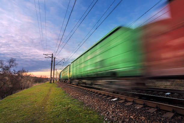 istock Railway station with cargo wagons in motion at sunset 635901502