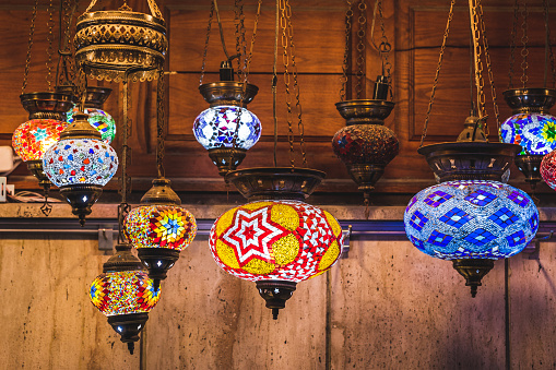 Amazing traditional handmade turkish lamps in souvenir shop. Mosaic of colored glass. Lit in the evening, creating a cozy atmosphere