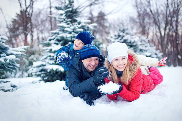 istock Attractive family having fun in a winter park 635902228
