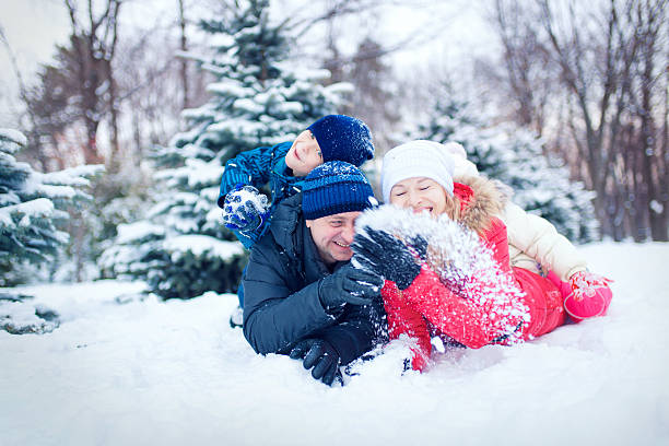 istock Attractive family having fun in a winter park 635902302