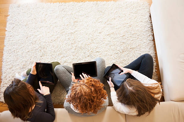 istock Teenage girls using digital tablet 635903412