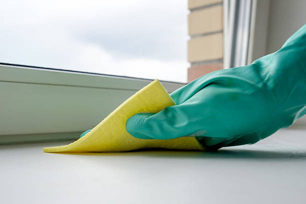 istock Cleaning windowsill with yellow cloth 635903950