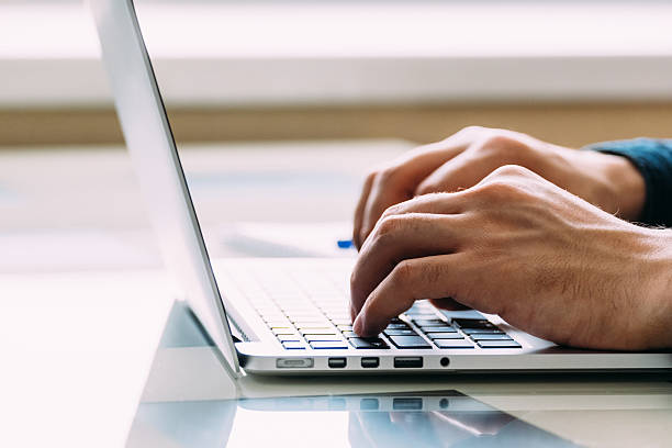 istock Businessmen's hands typing on laptop 635905534