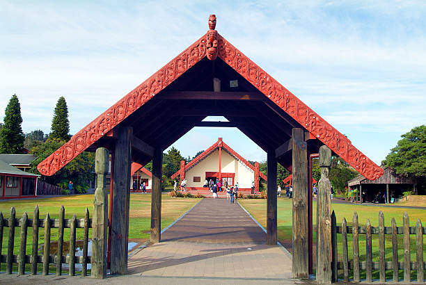 New Zealand, Rotorua Rotorua, New Zealand - March 11, 2005: Unidentified people in Whakarewarewa Thermal Park, buildings with Maori ornaments whakarewarewa stock pictures, royalty-free photos & images