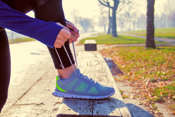 istock Unrecognizable young runner tying her shoelaces 635909248