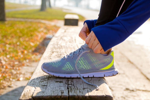 istock Unrecognizable young runner tying her shoelaces 635909470