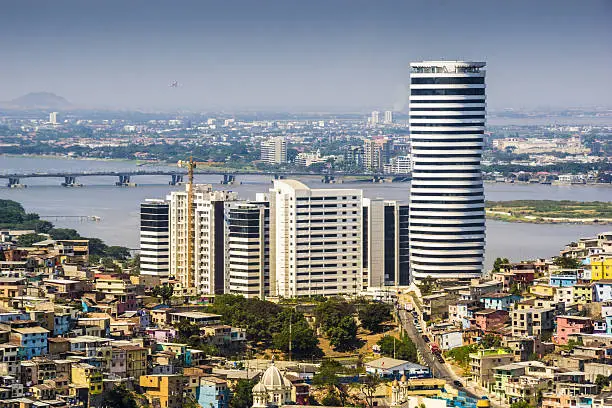 A top view of Guayaquil city in Ecuador. Buildings, Puerto Santa Ana buildings and the Guayas river. Sunny no clouds.