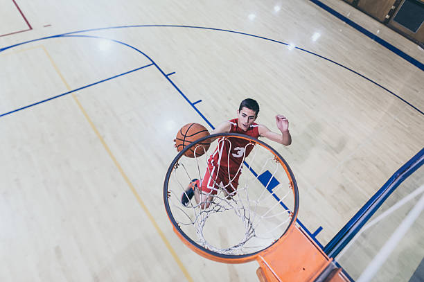 istock Male high school basketball player going up for a 635909906