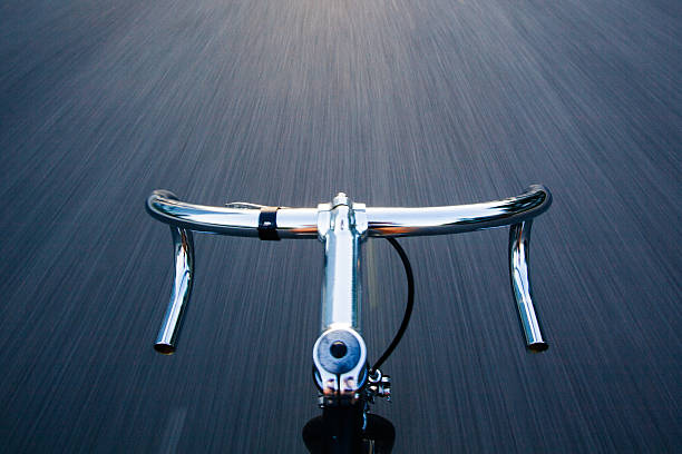 Riding a steel and chrome bike on the road.