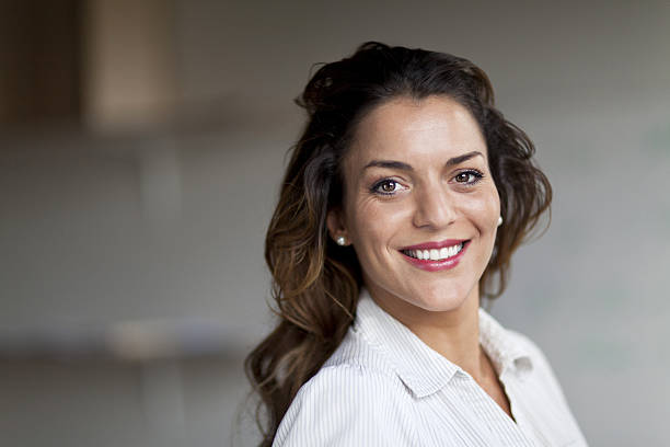 Spanish Businesswoman Smiling At the Camera. At the office. stock photo