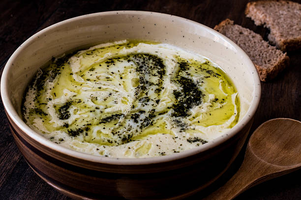Turkish Yayla or Yogurt Soup with mint sauce (Tzatziki) Turkish Yayla or Yogurt Soup with mint sauce (Tzatziki) on a wooden surface plateau concept stock pictures, royalty-free photos & images