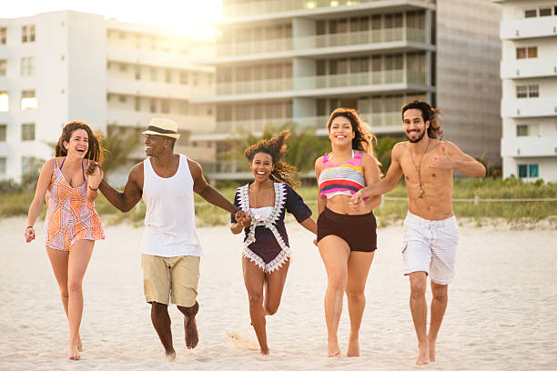 istock Group of friends running on the beach 635913310