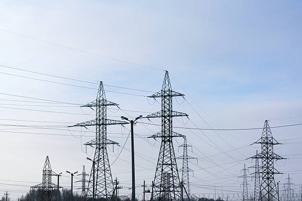 istock Several metal electricity pylon in the field. 635913492