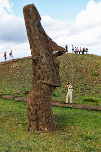 Photographer photographing Moai at Rano Raraku volcanic quarry on Easter Island, Chile.