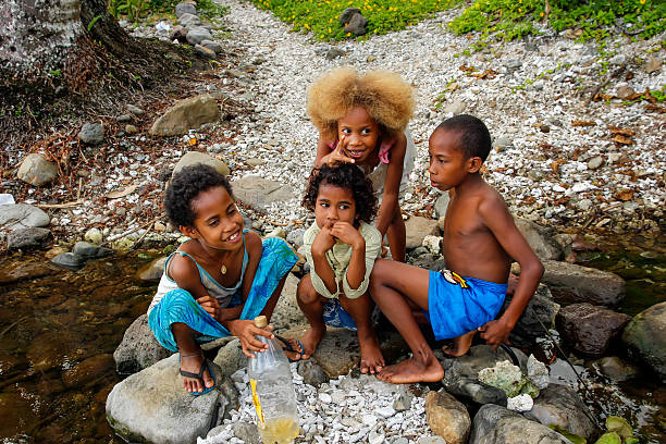 Taveuni, Fiji - November 25, 2013: Local kids playing by the river along Lavena Coastal Walk, Taveuni Island, Fiji. Taveuni is the third largest island in Fiji.