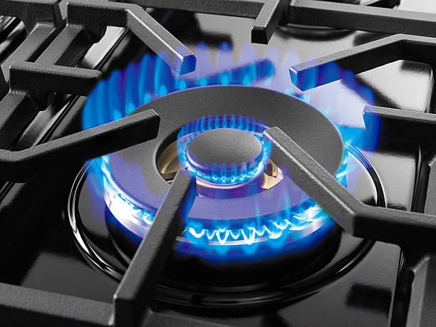 Blue gas flame Male chef cooking vegetables. camping stove photos stock pictures, royalty-free photos & images