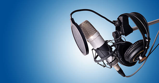 istock Studio condenser microphone and equipment blue isolated 635926486