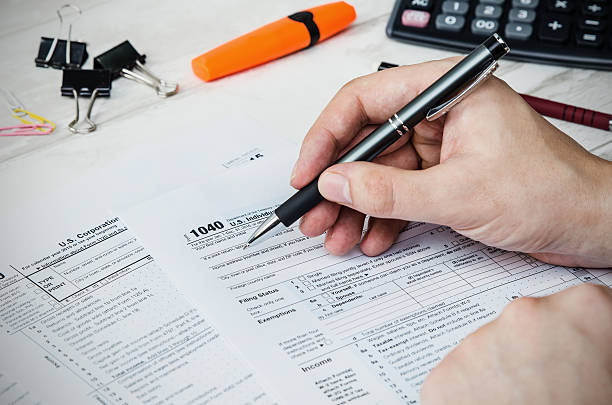 istock Man filling US tax form 635932328