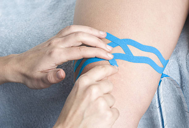 istock Lymphatic knee technique, two fan strips. Kinesiology Tape 635932418