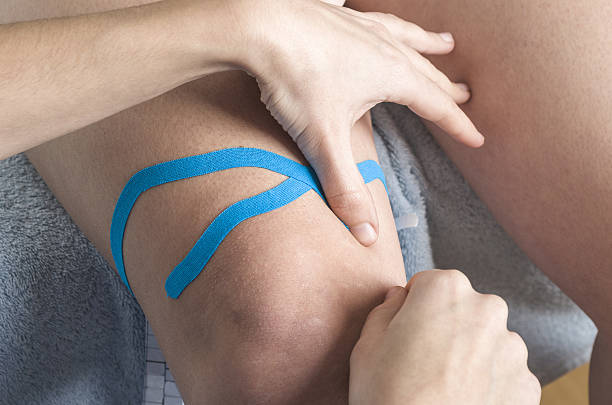 istock Lymphatic knee technique, two fan strips. Kinesiology Tape 635932560